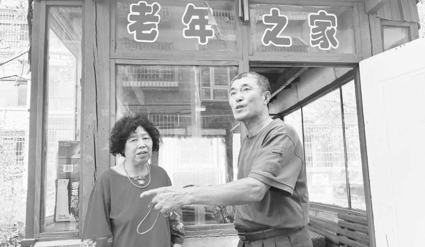 丹东凤城市凤山街道铁北社区兼职网格员杜宝富（右）介绍把凉亭封闭起来的好处。